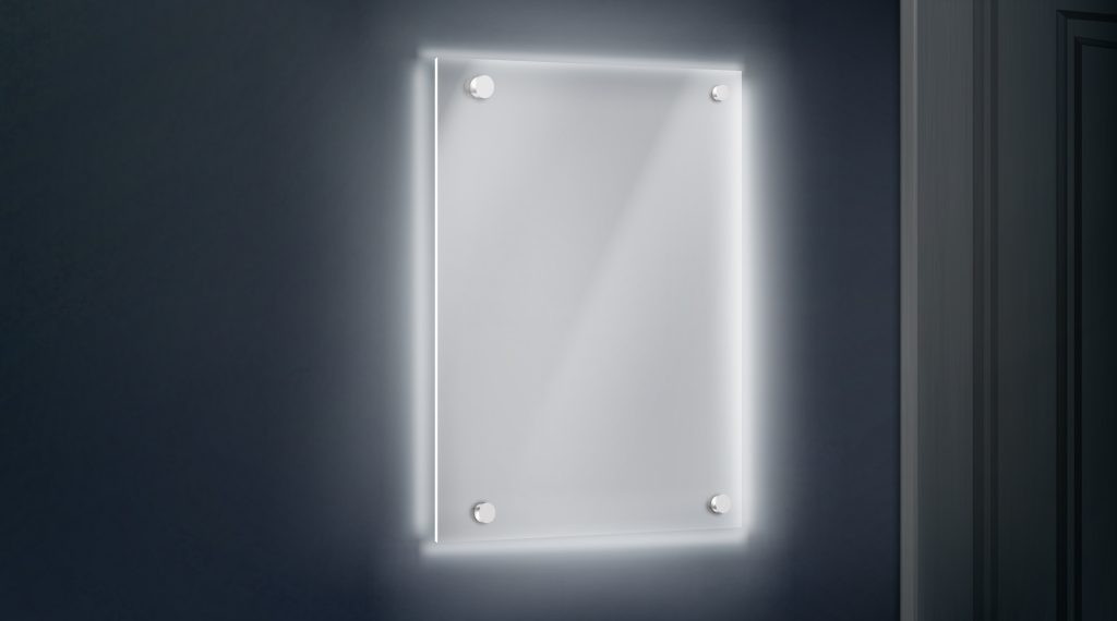 empty glass name plate bolted to wall near doorway